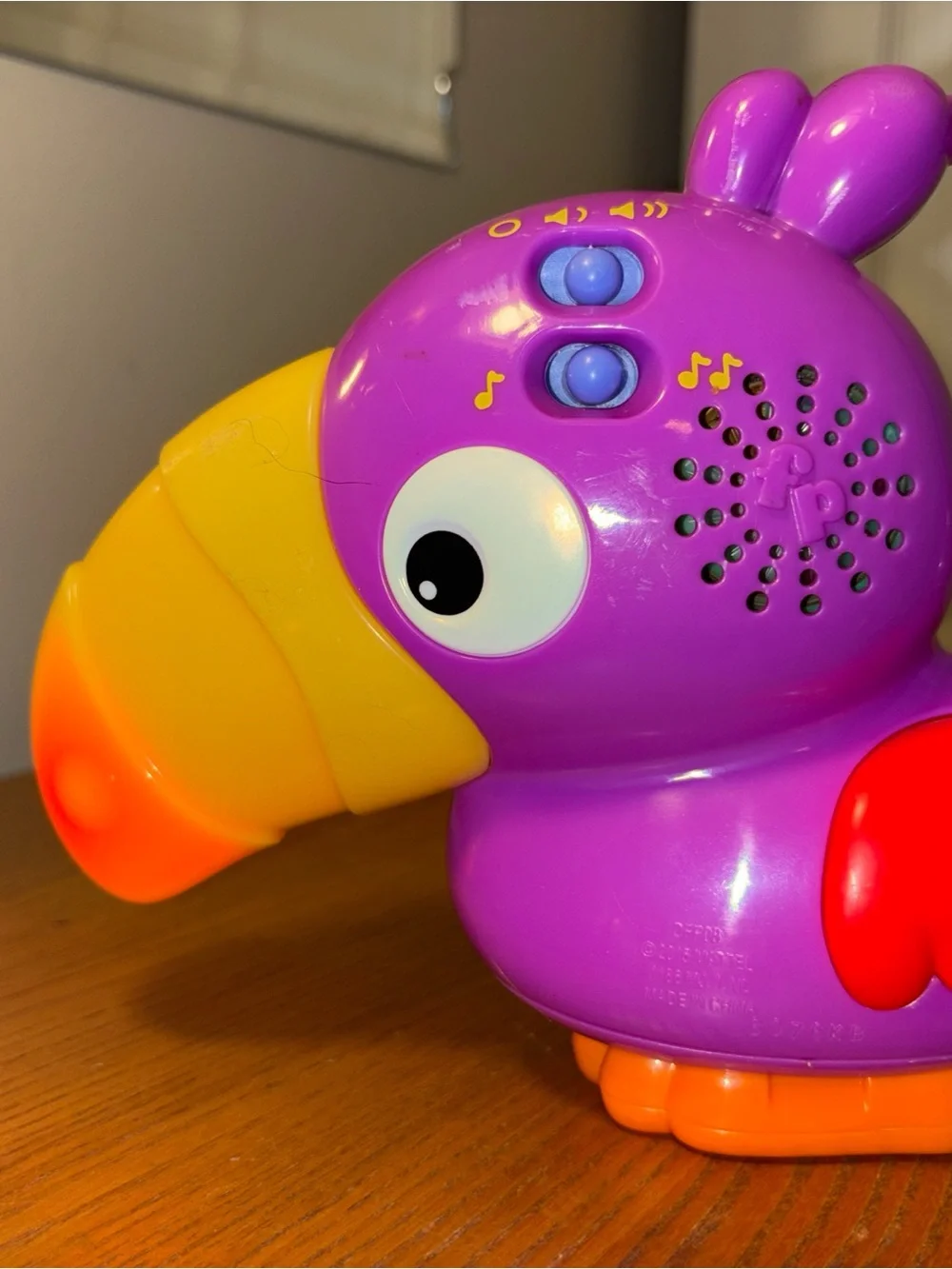 Fisher-Price Vibrant Purple Parrot Toy with Yellow Beak works great